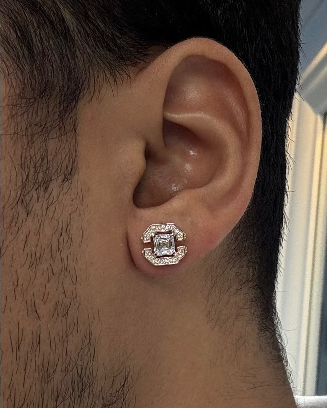 Men's brilliant princess cut diamond stud earrings, close-up of half halo setting